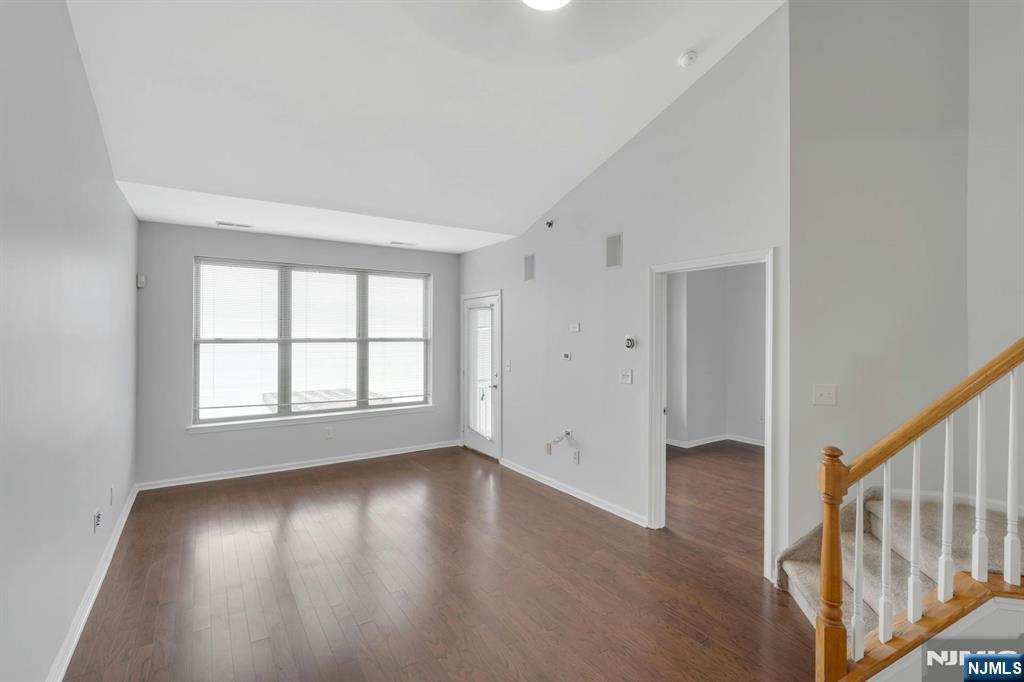 24 Ave At Port Imperial, Unit 401 West New York, NJ 07093 - Photo 6 of 27 a view of an empty room with wooden floor and a window