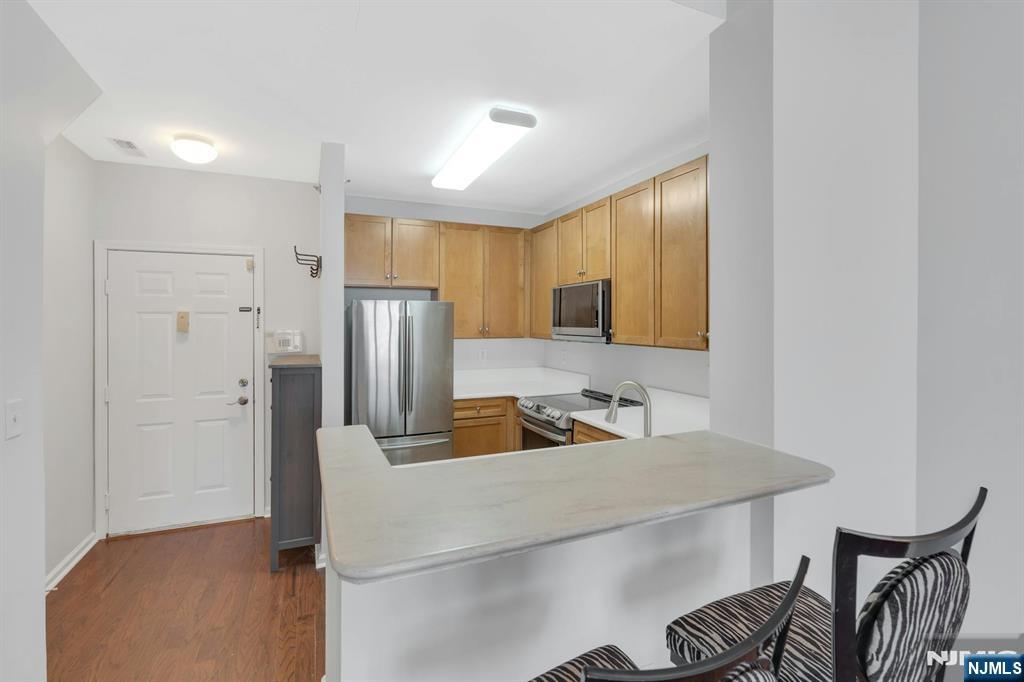 24 Ave At Port Imperial, Unit 401 West New York, NJ 07093 - Photo 9 of 27 a kitchen with a refrigerator and a sink