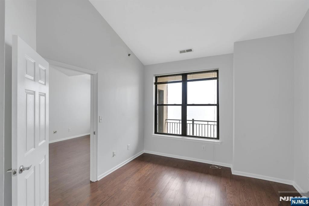 24 Ave At Port Imperial, Unit 401 West New York, NJ 07093 - Photo 10 of 27 an empty room with wooden floor and windows