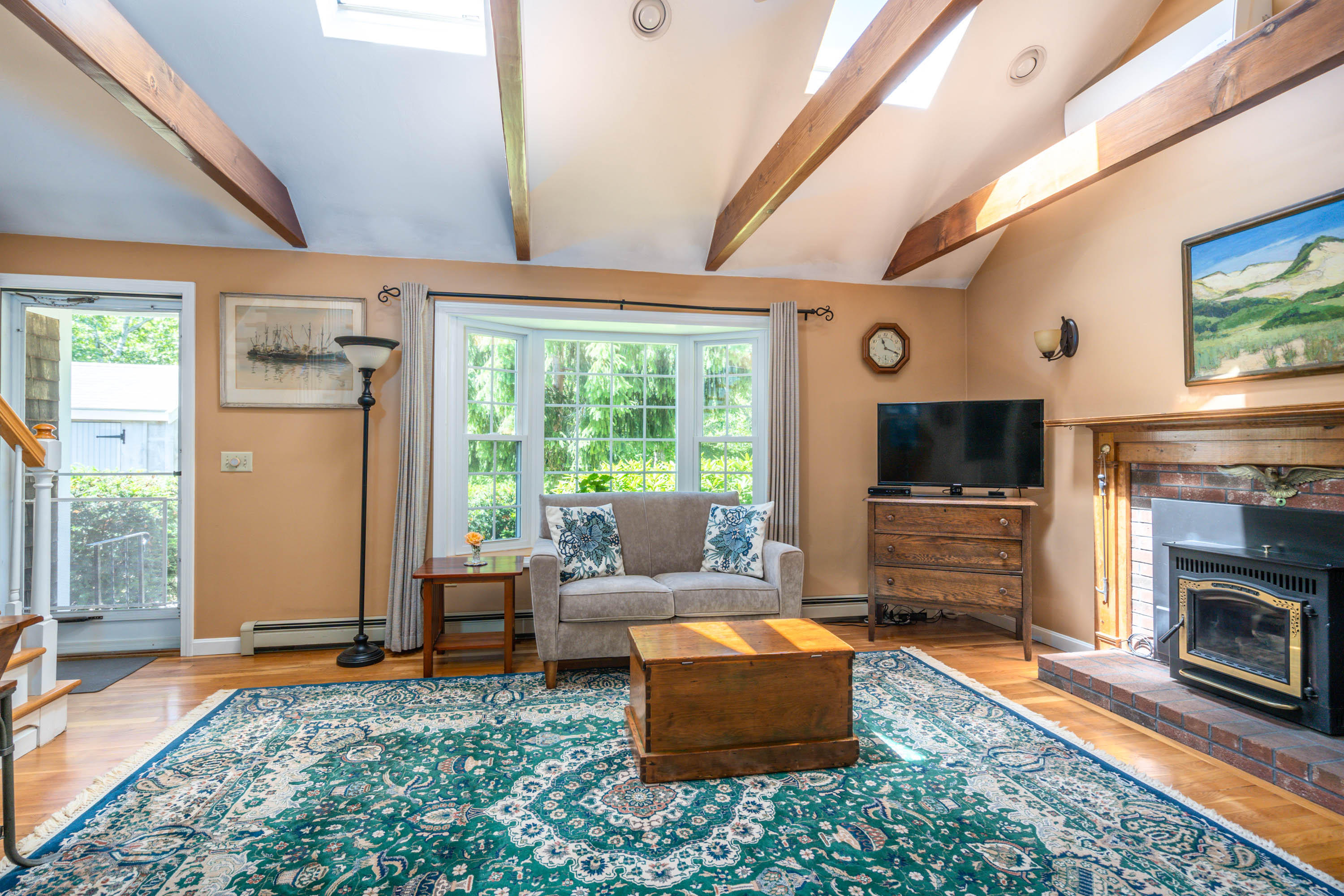 3010 State Hwy Route Wellfleet, MA 02667 - Photo 8 of 30 a living room with furniture a flat screen tv and a fireplace
