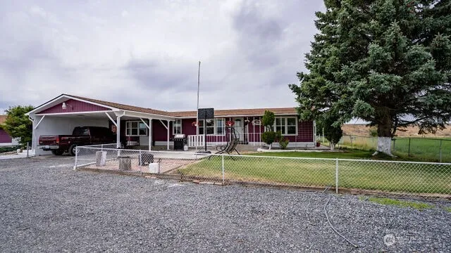 a backyard of a house with lots of green space and mountain view in back