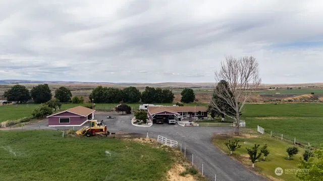 a car parked in the grass near a yard
