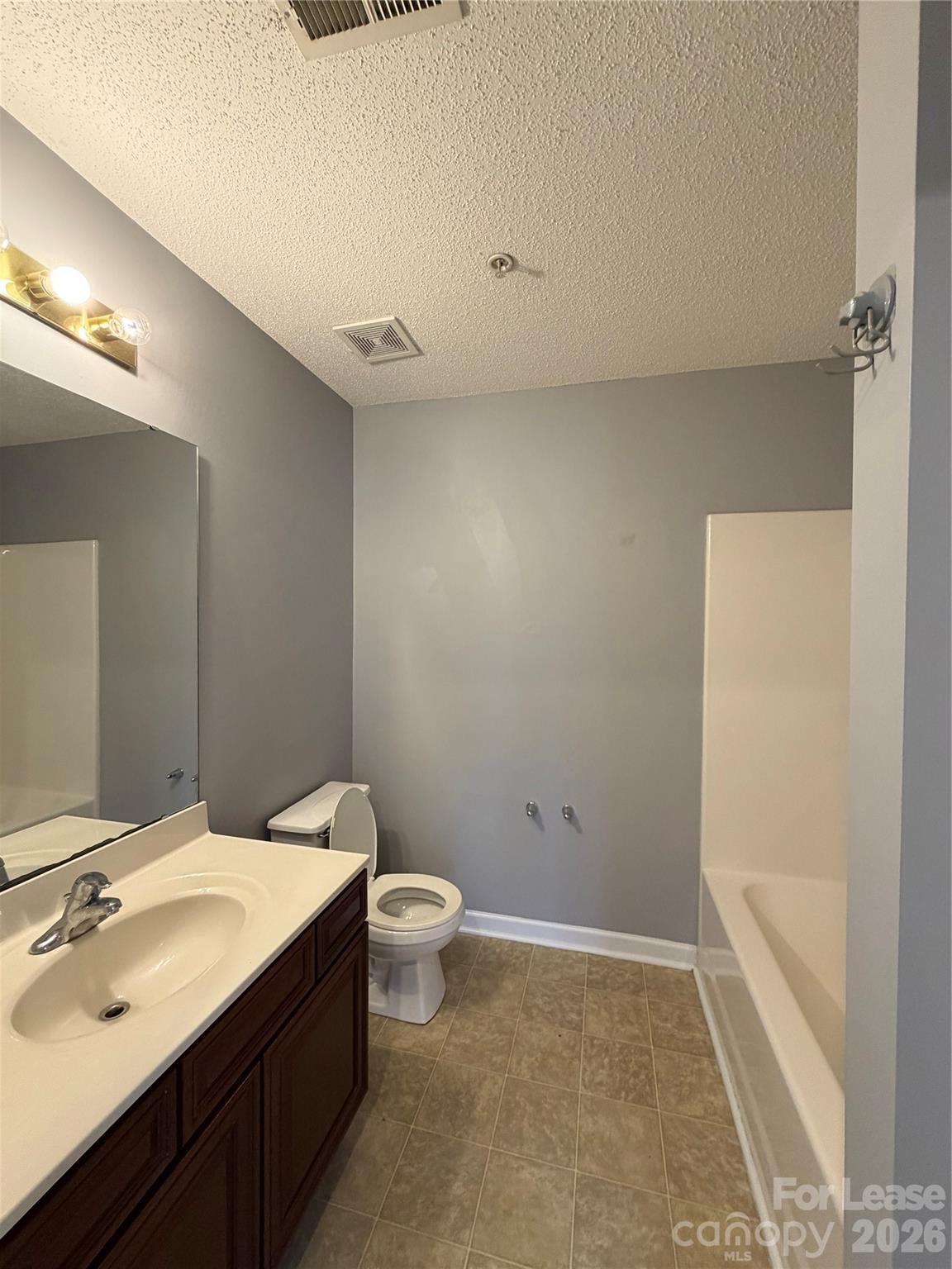 110 Steam Engine Drive, Unit 202 Mooresville, NC 28115 - Photo 16 of 26 a bathroom with a sink a toilet and shower
