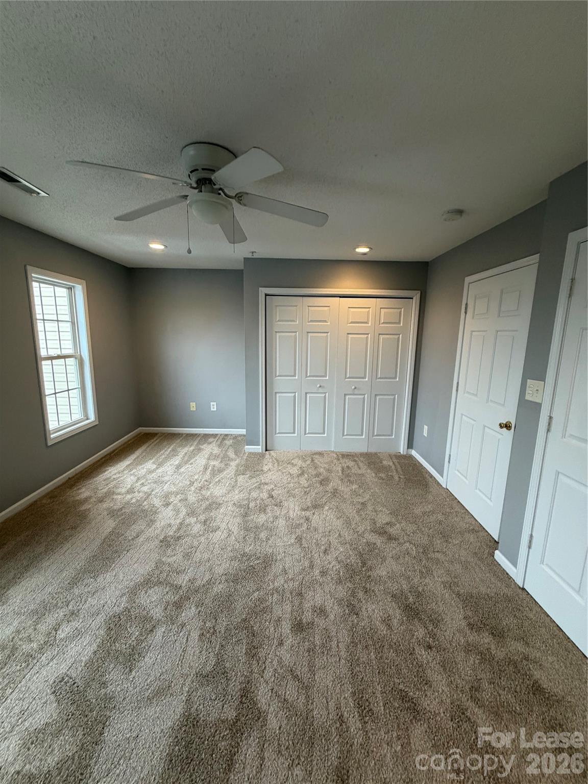 110 Steam Engine Drive, Unit 202 Mooresville, NC 28115 - Photo 22 of 26 a view of an empty room with a window