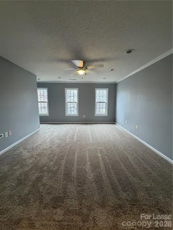 a view of wooden floor and windows in a room