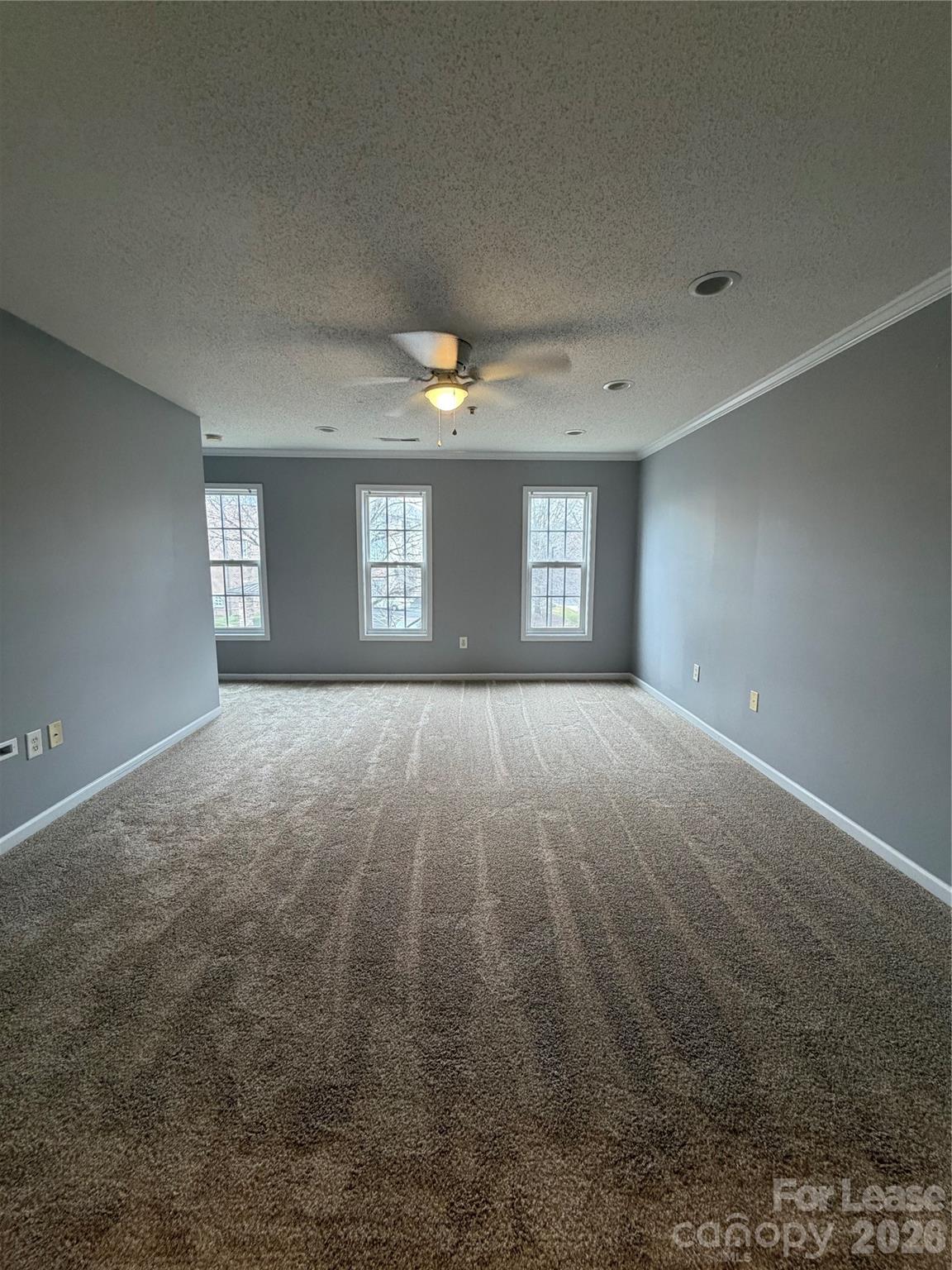 110 Steam Engine Drive, Unit 202 Mooresville, NC 28115 - Photo 3 of 26 a view of wooden floor and windows in a room