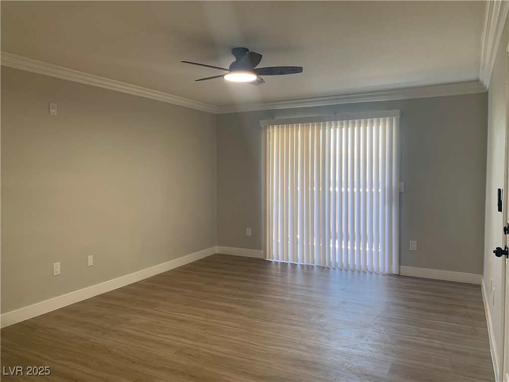 8101 West Flamingo Road, Unit 1102 Las Vegas, NV 89147 - Photo 9 of 54 Living room with crown molding, plenty of natural light, wood finished floors, and ceiling fan