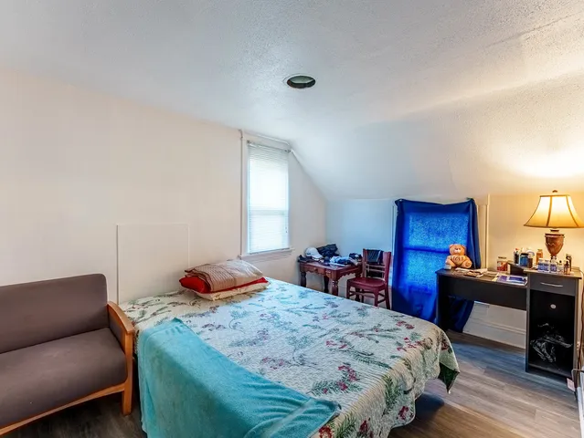 a bedroom with a bed and a desk