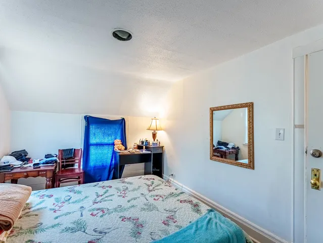 a bedroom with a bed and a desk