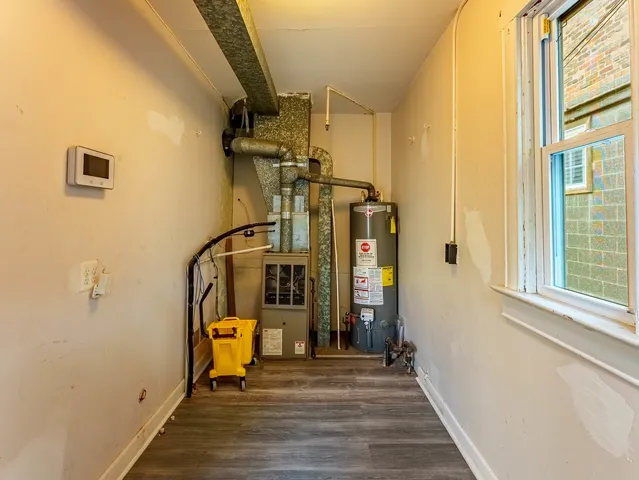 a view of a room that has a window and wooden floor