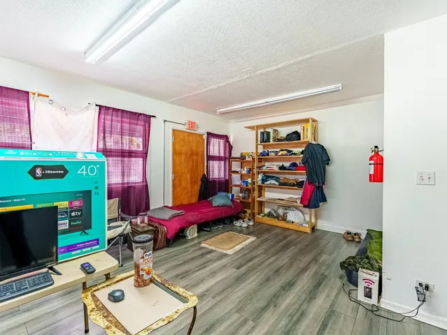 a room with furniture a flat screen tv and a window