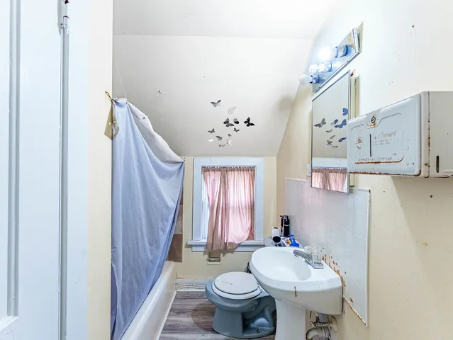 a bathroom with a sink toilet and a mirror