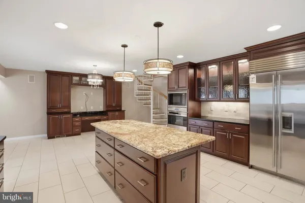 a kitchen with stainless steel appliances a stove and cabinets