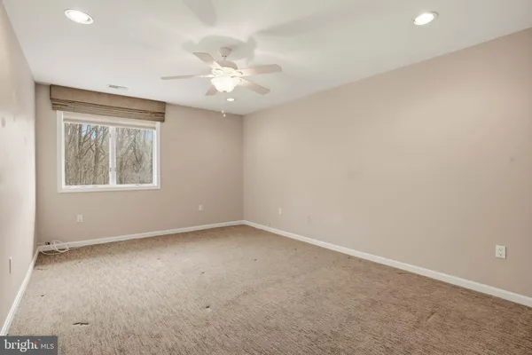 a kitchen with stainless steel appliances granite countertop a sink a stove a microwave a refrigerator a stove and white cabinets