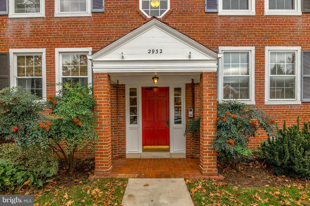 a view of a brick house with large windows