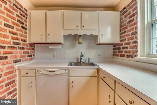 a kitchen with appliances cabinets and a sink