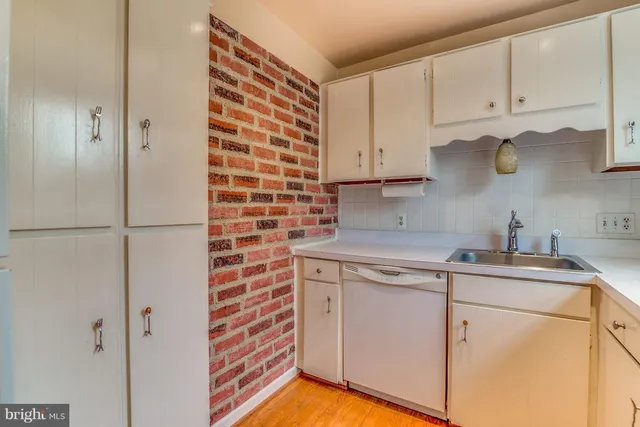 a kitchen with stainless steel appliances granite countertop a sink and a stove