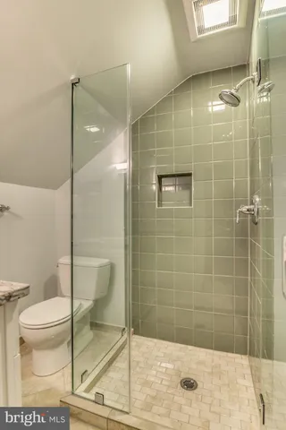 a bathroom with a shower and toilet