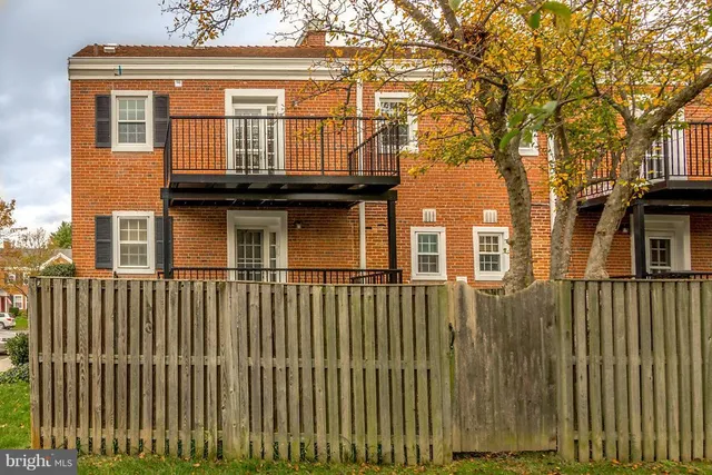 a view of a house with wooden fence