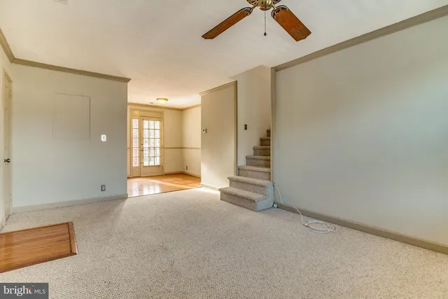 an empty room with windows and cabinet