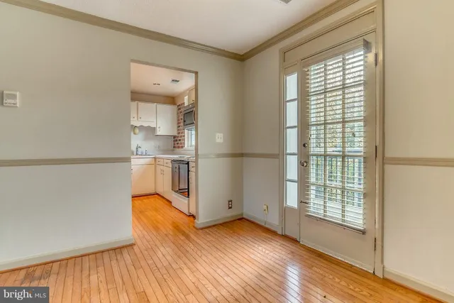 a view of kitchen with wooden floor and a window