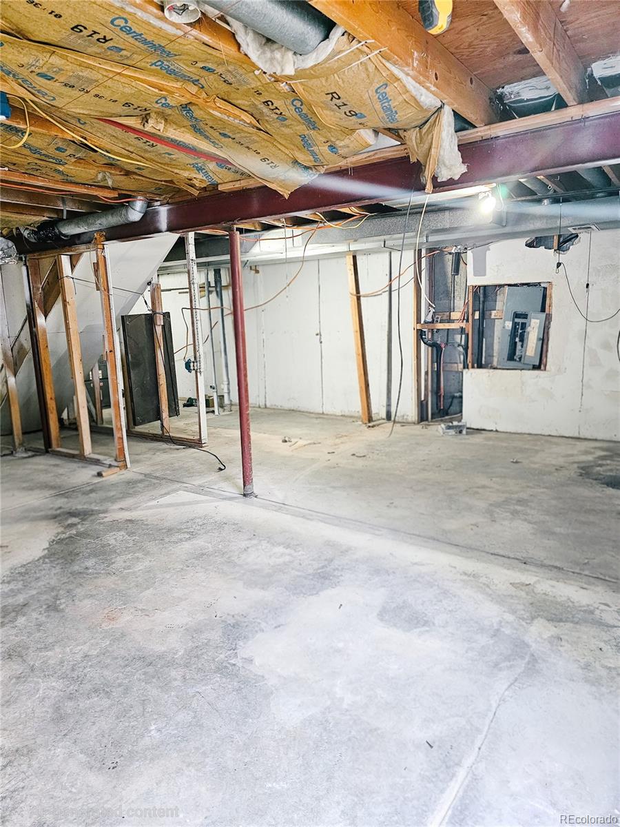 4716 Freeport Way Denver, CO 80239 - Photo 28 of 29 a view of a room with wooden walls