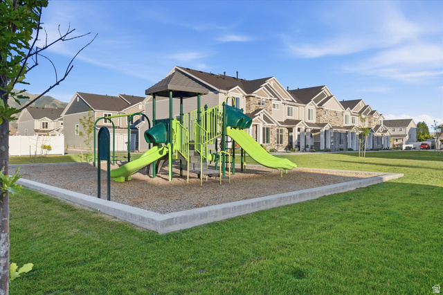 2257 South 1090 West, Unit 74 Nibley, UT 84321 - Photo 24 of 40 Community playground featuring a playset with slides and climbing structures, surrounded by a wood chip surface