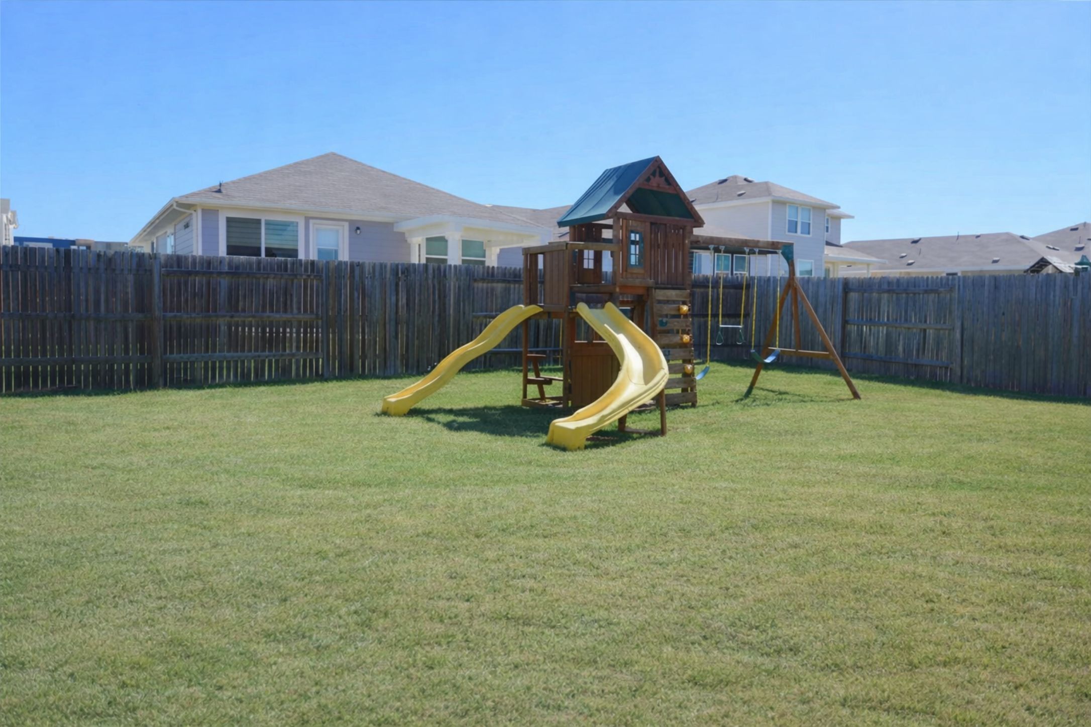153 Blue Agate Court Jarrell, TX 76537 - Photo 19 of 20 a view of a house with a backyard and a slide