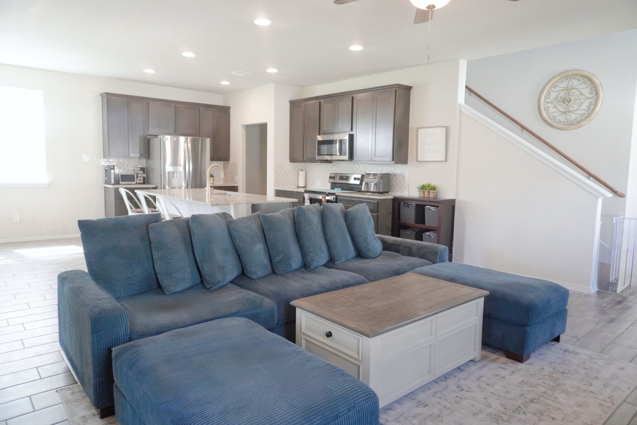153 Blue Agate Court Jarrell, TX 76537 - Photo 5 of 20 a living room with furniture a clock and kitchen view