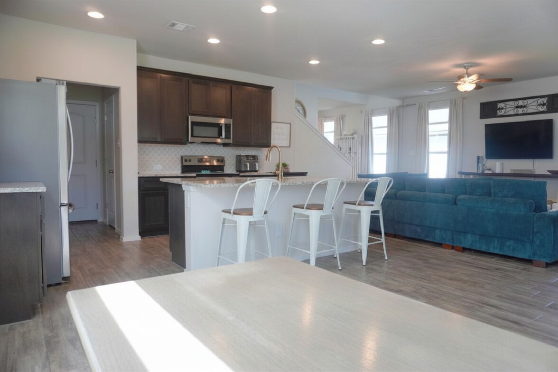 153 Blue Agate Court Jarrell, TX 76537 - Photo 20 of 20 a kitchen with stainless steel appliances kitchen island granite countertop a stove a sink a refrigerator and a microwave