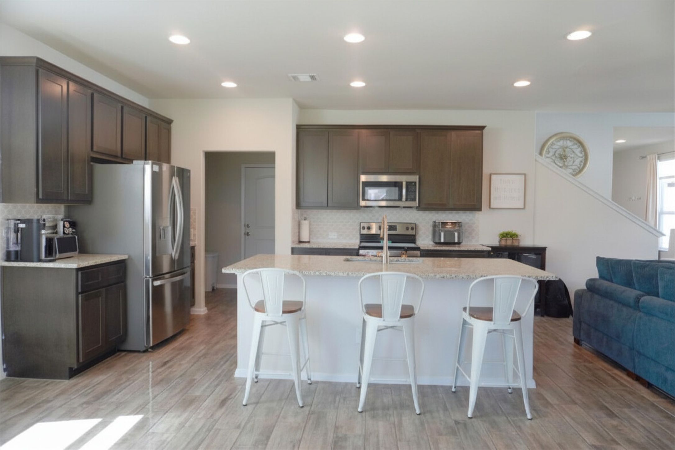 153 Blue Agate Court Jarrell, TX 76537 - Photo 7 of 20 a large kitchen with a table chairs refrigerator and a sink