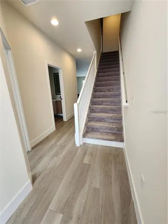 a view of entryway and hall with wooden floor
