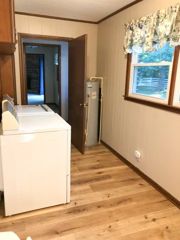 a view of washer and dryer with wooden floor