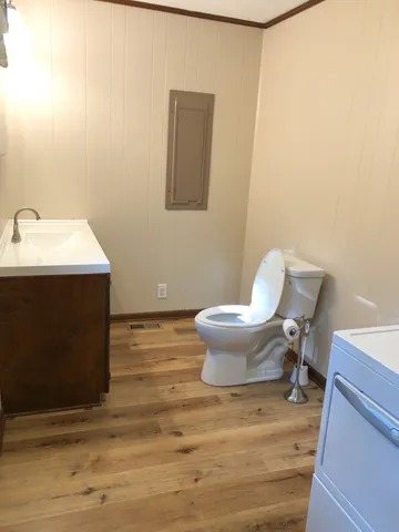 a bathroom with a sink toilet and mirror