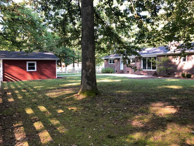 a view of a house with a yard