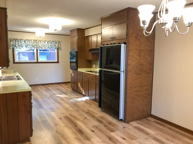 a kitchen with stainless steel appliances granite countertop a refrigerator and a stove