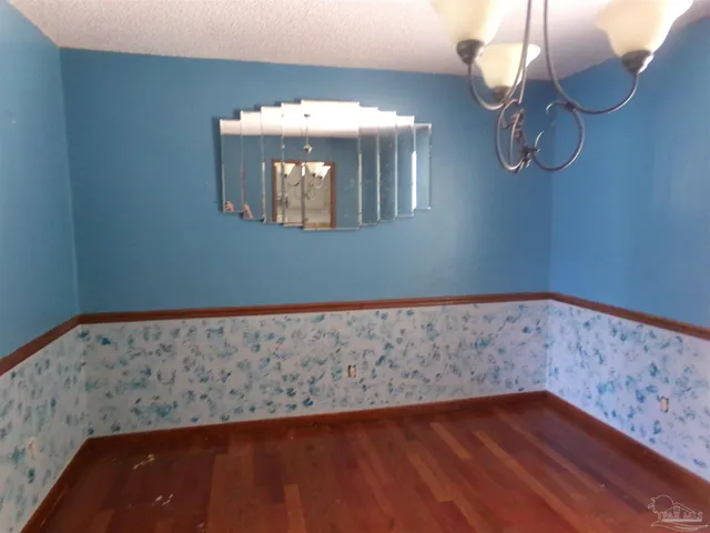 a view of room with wooden floor