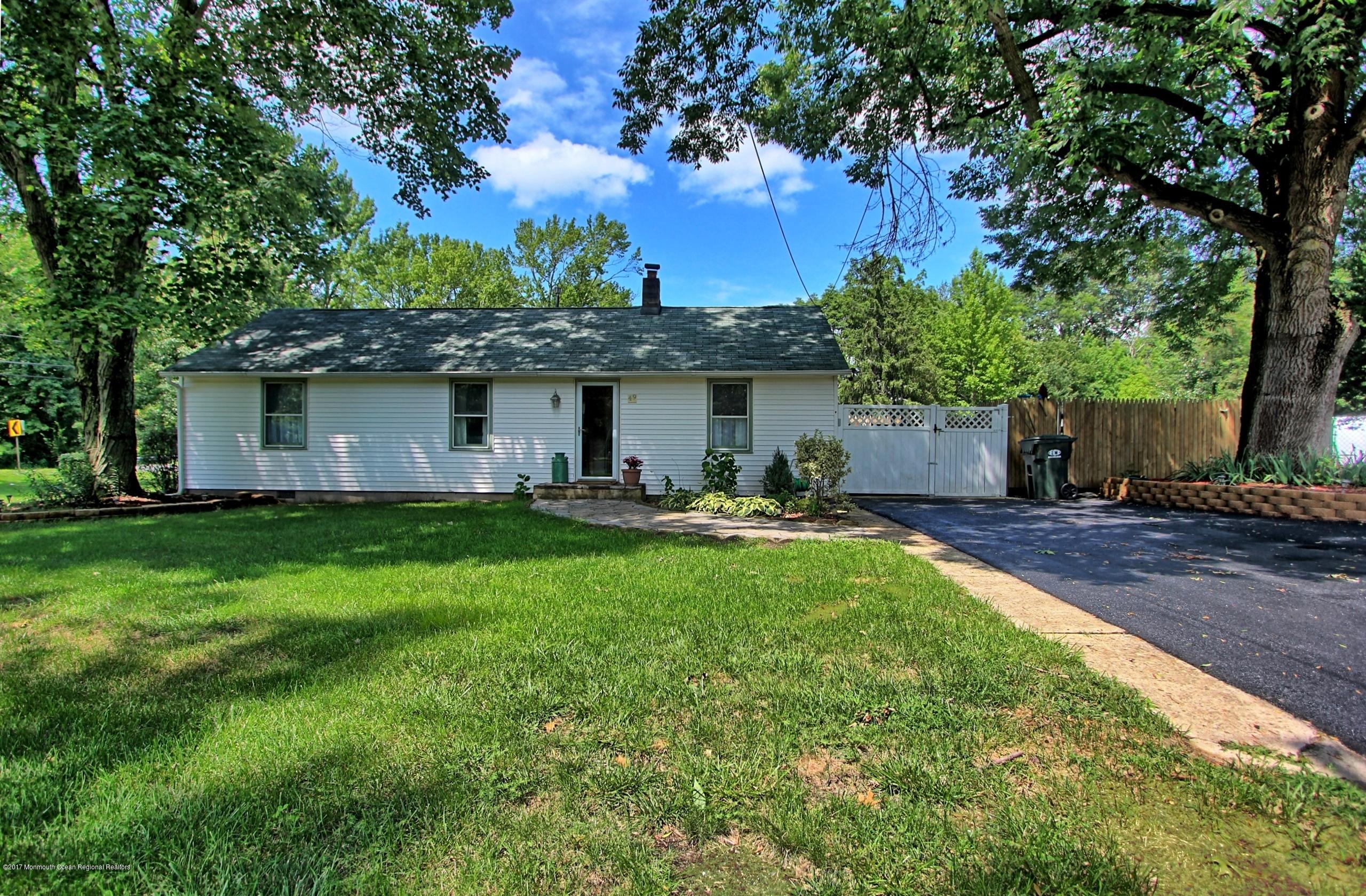 a front view of house with yard and outdoor seating