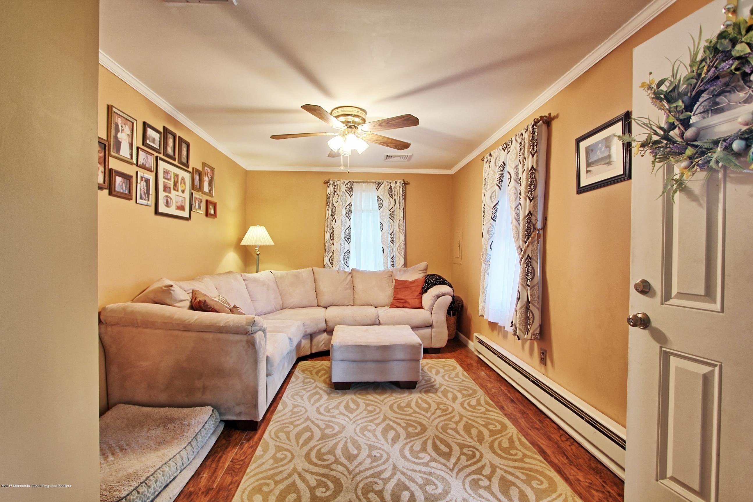 49 Siloam Road Freehold, NJ 07728 - Photo 11 of 38 a living room with furniture and a rug