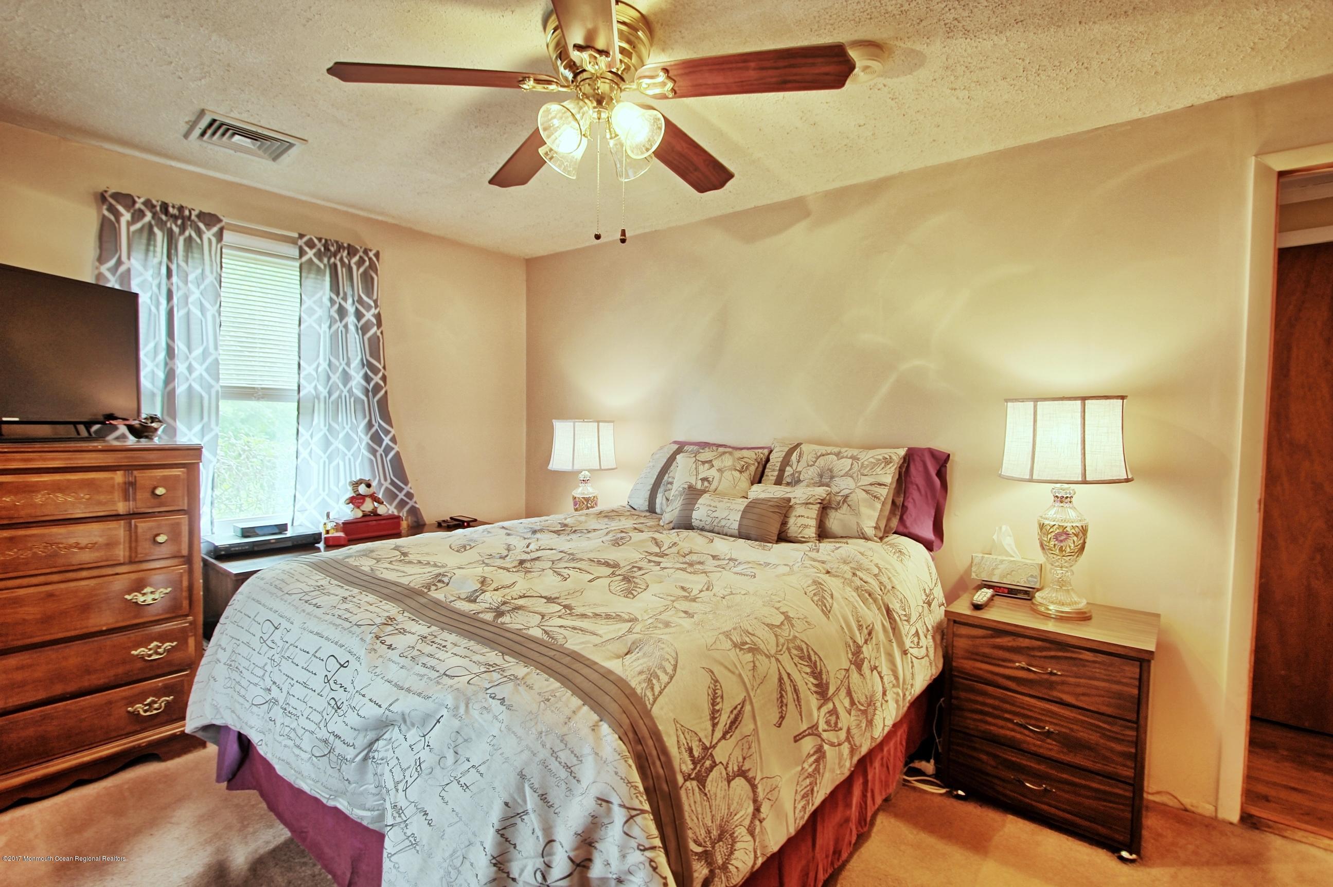 49 Siloam Road Freehold, NJ 07728 - Photo 12 of 38 a bedroom with a bed and a flat screen tv
