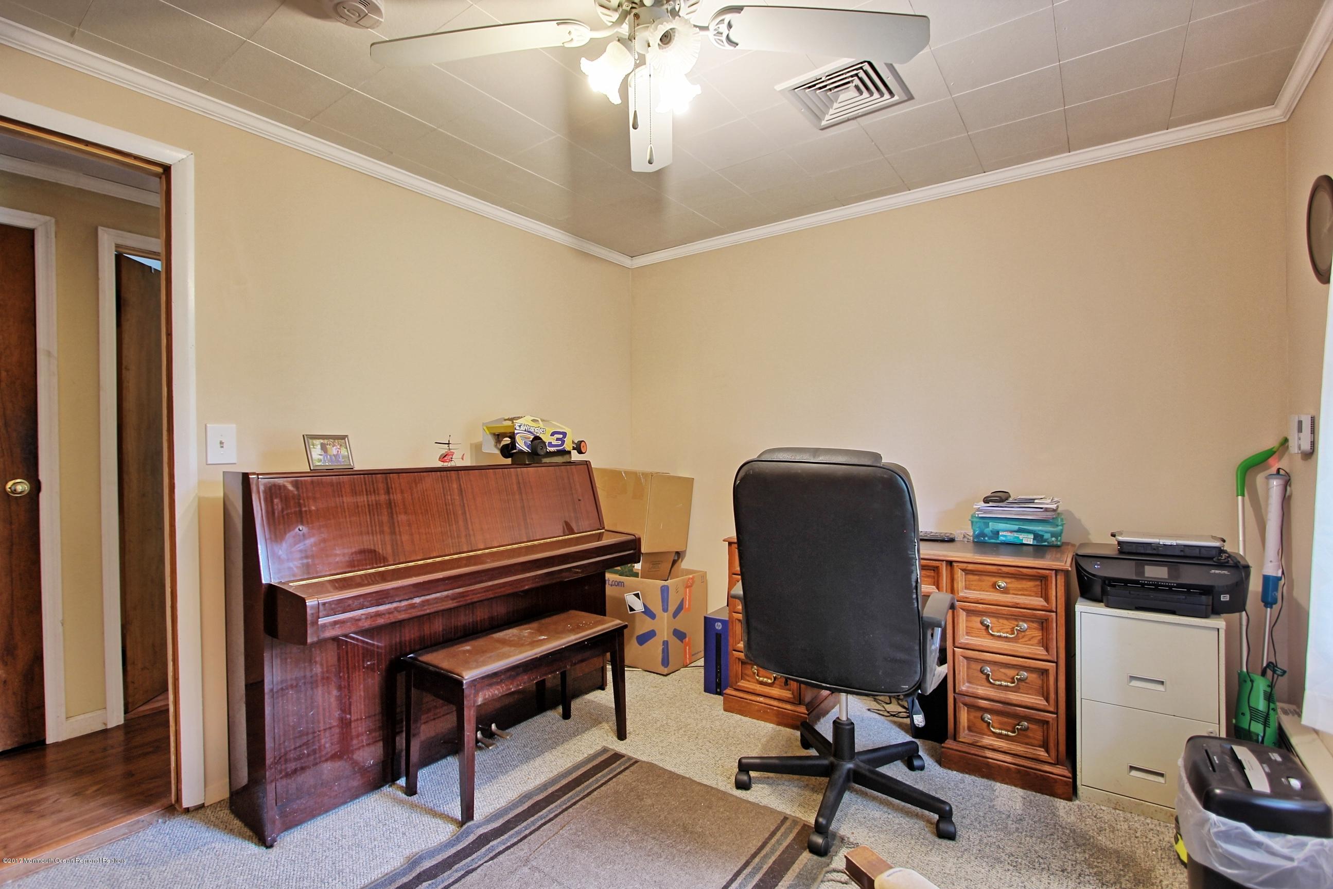 49 Siloam Road Freehold, NJ 07728 - Photo 18 of 38 a view of a workspace with furniture and a ceiling fan