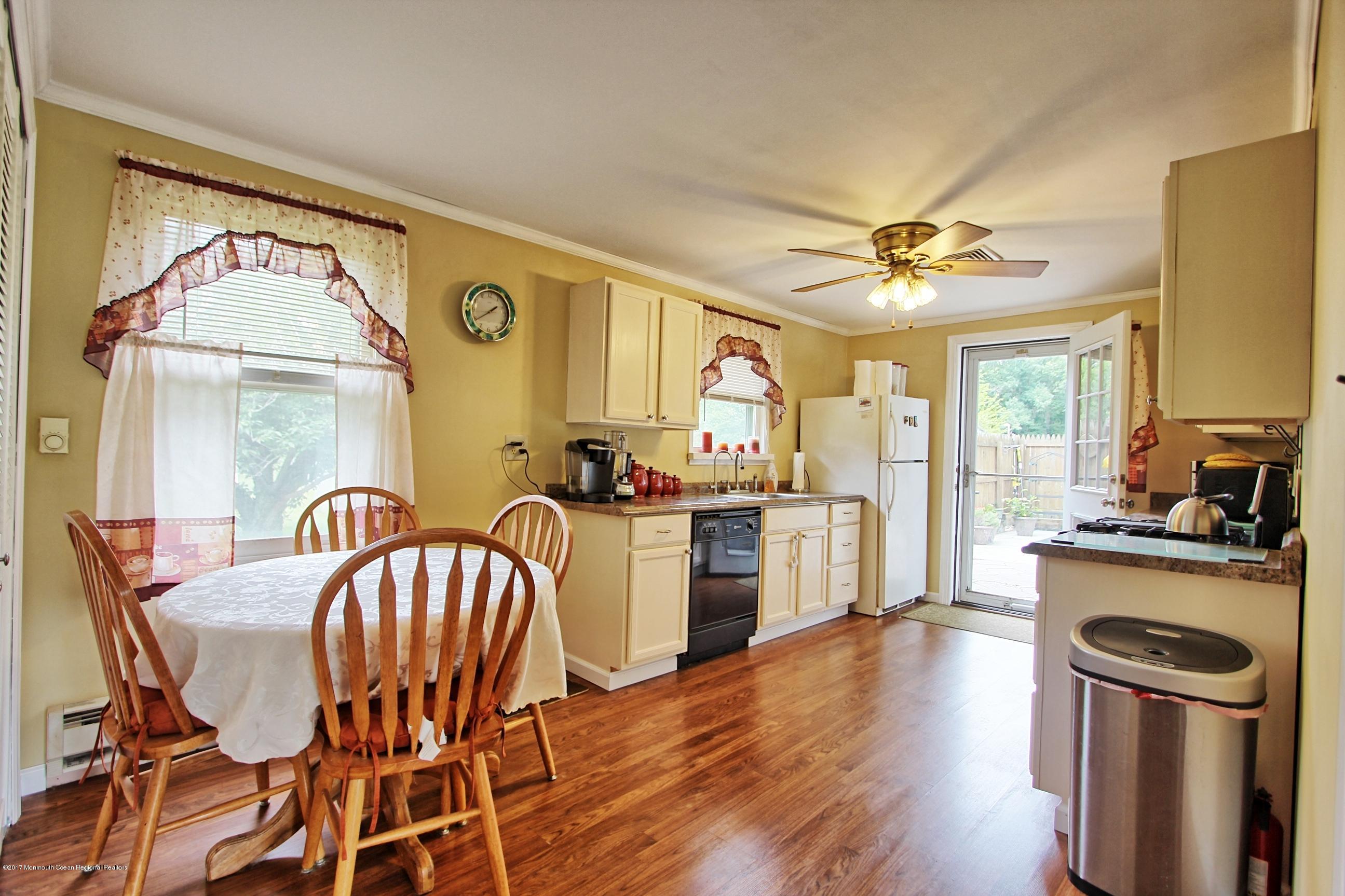 49 Siloam Road Freehold, NJ 07728 - Photo 2 of 38 a kitchen with a table chairs refrigerator and cabinets