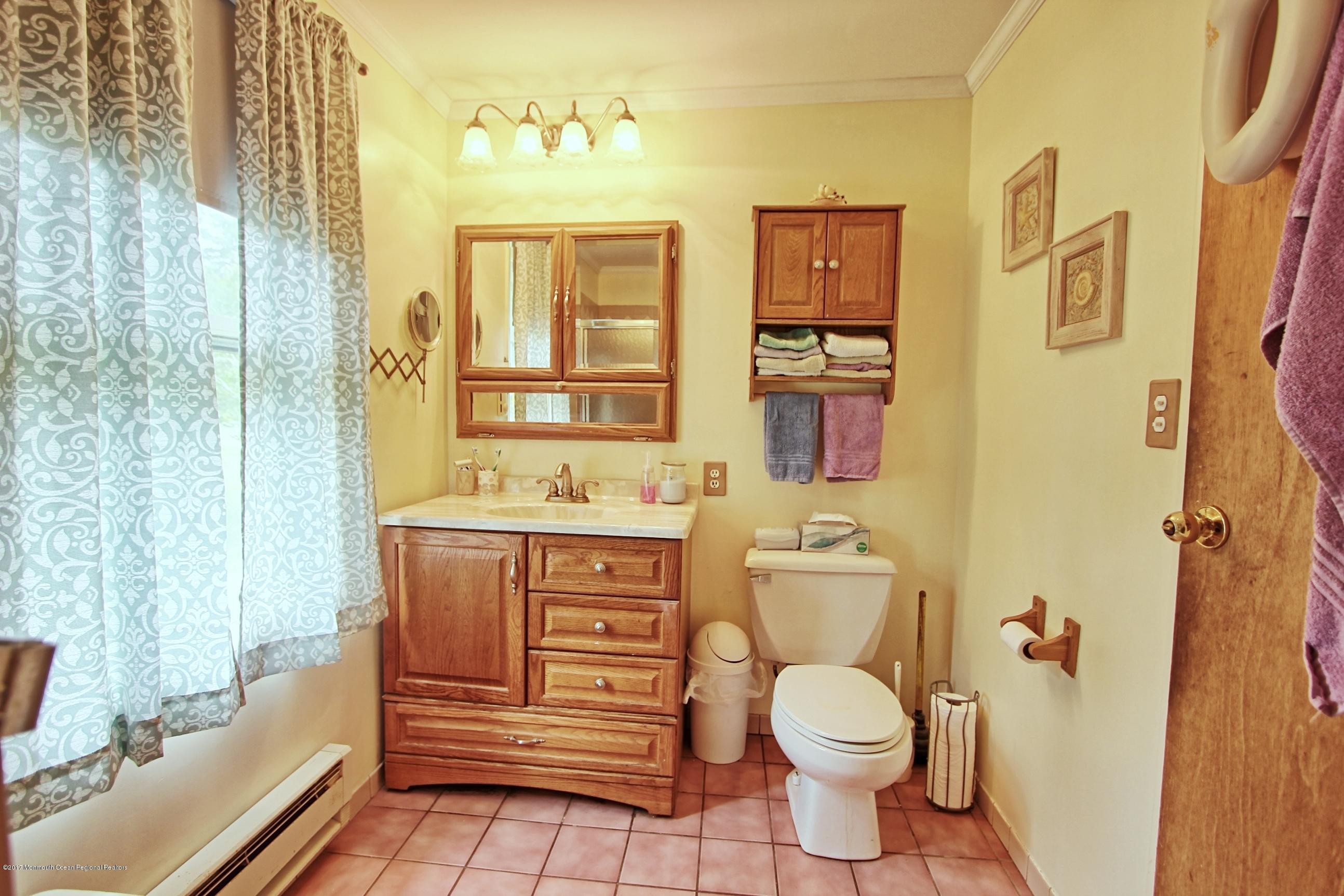 49 Siloam Road Freehold, NJ 07728 - Photo 21 of 38 a bathroom with a granite countertop toilet sink and mirror