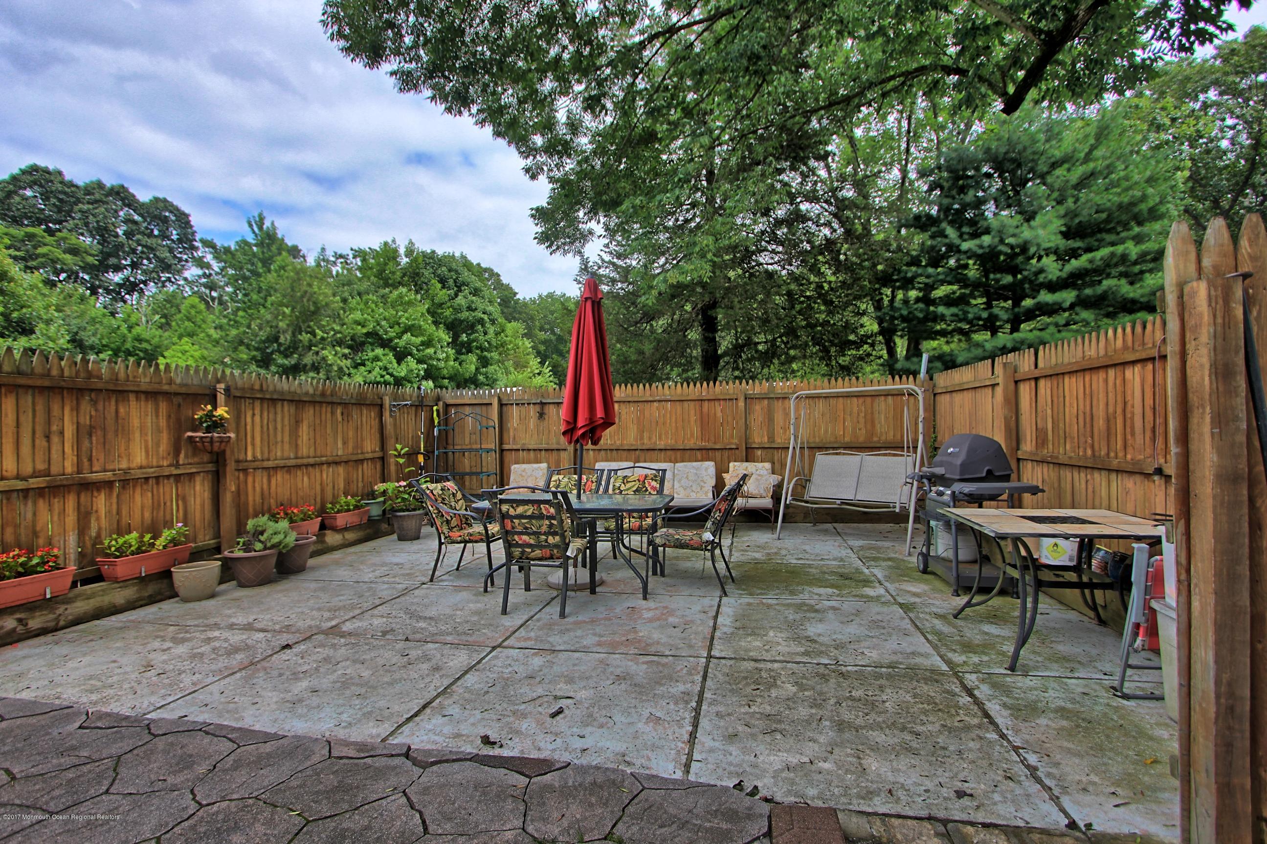 49 Siloam Road Freehold, NJ 07728 - Photo 22 of 38 a view of a tables and chairs in the back yard of the house