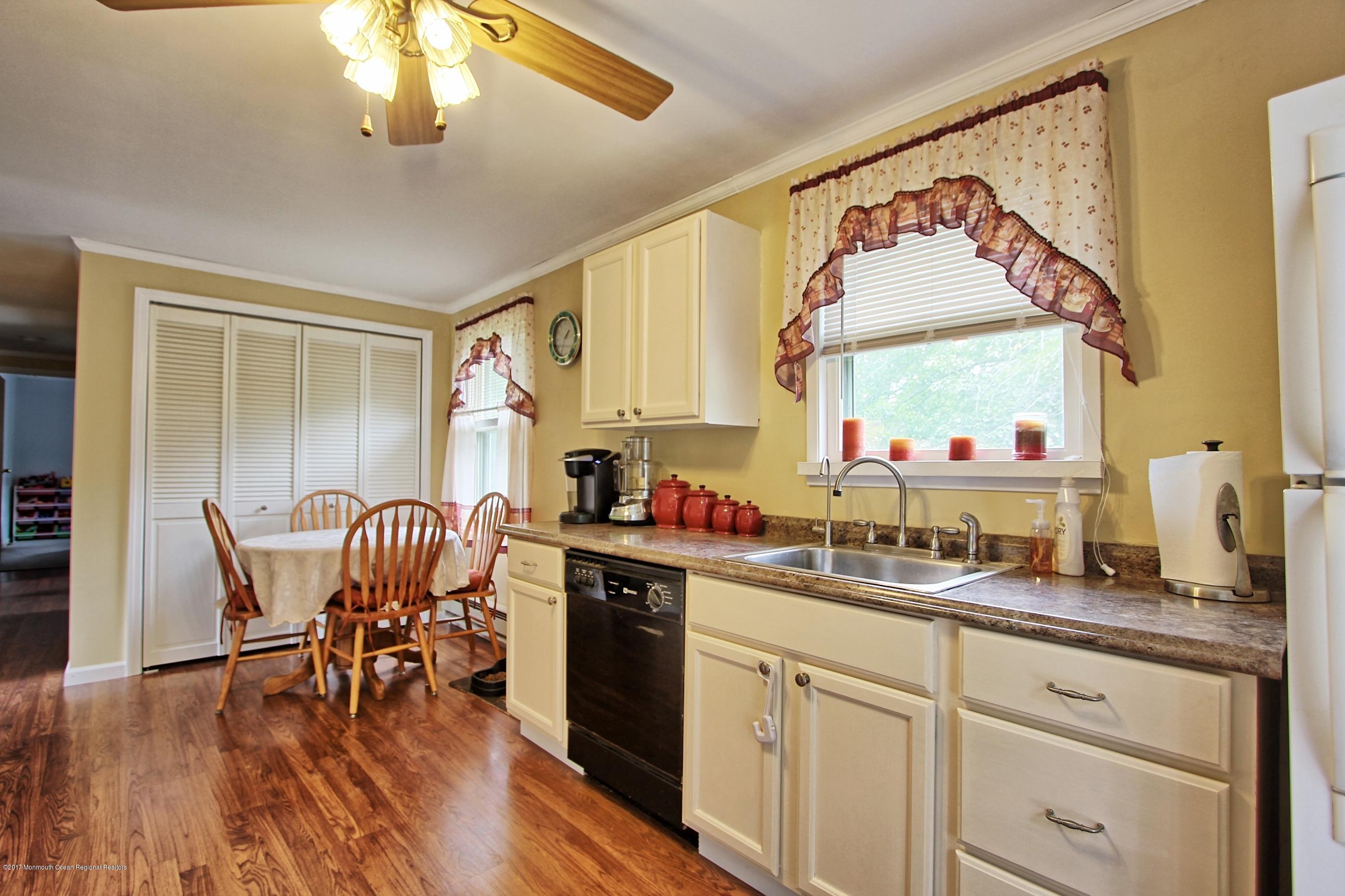 49 Siloam Road Freehold, NJ 07728 - Photo 3 of 38 a kitchen with a table chairs stove and cabinets