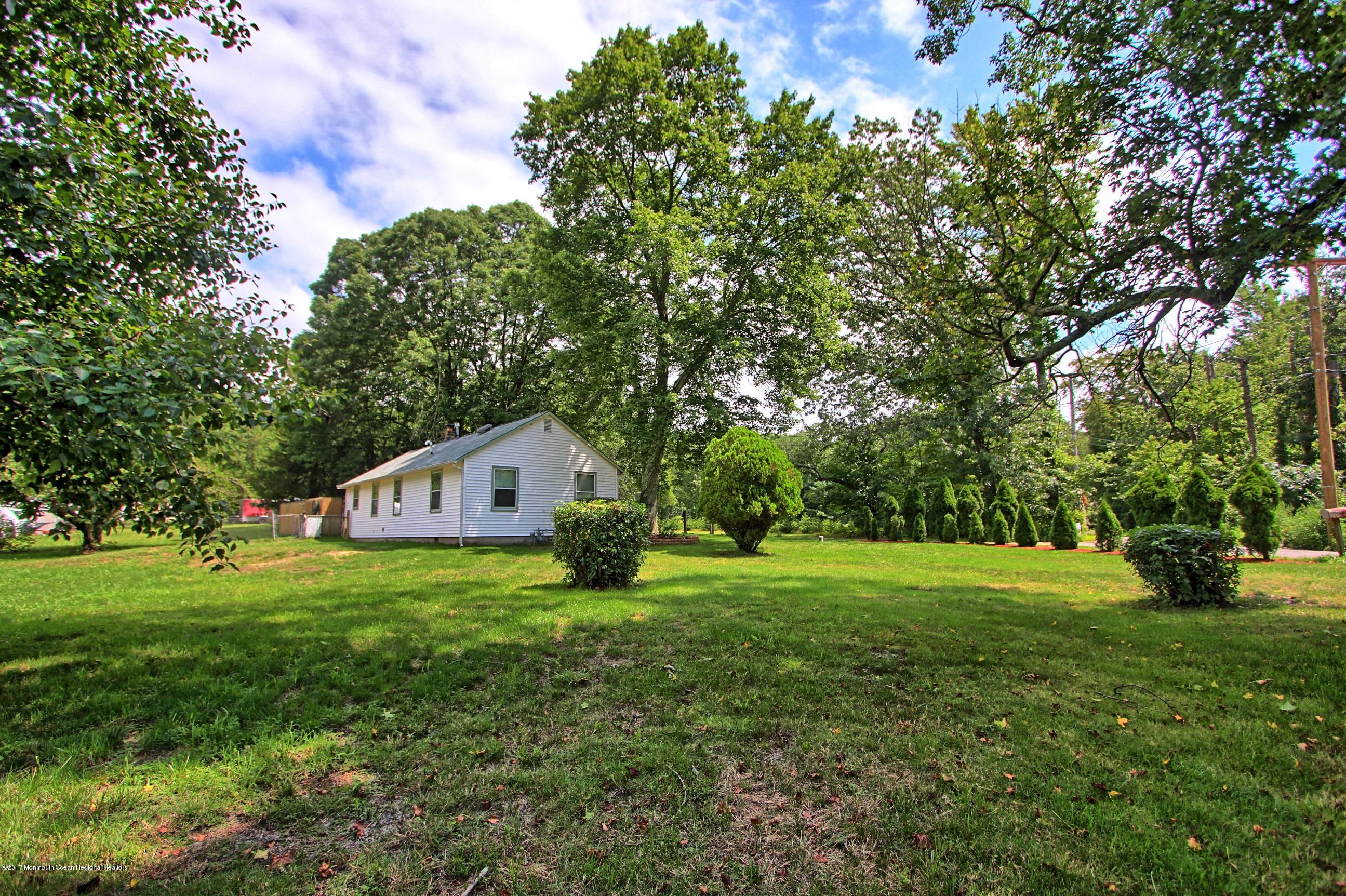 49 Siloam Road Freehold, NJ 07728 - Photo 35 of 38 a house with a big yard and large trees