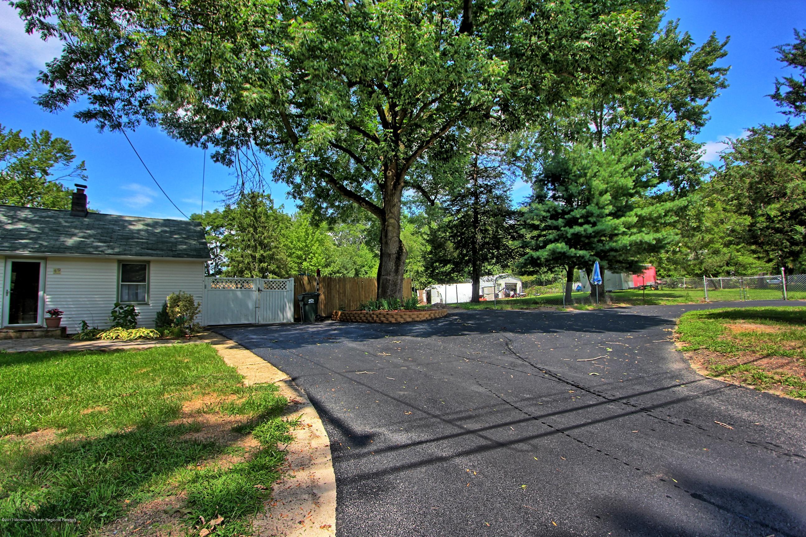 49 Siloam Road Freehold, NJ 07728 - Photo 36 of 38 a front view of a house with a yard and trees