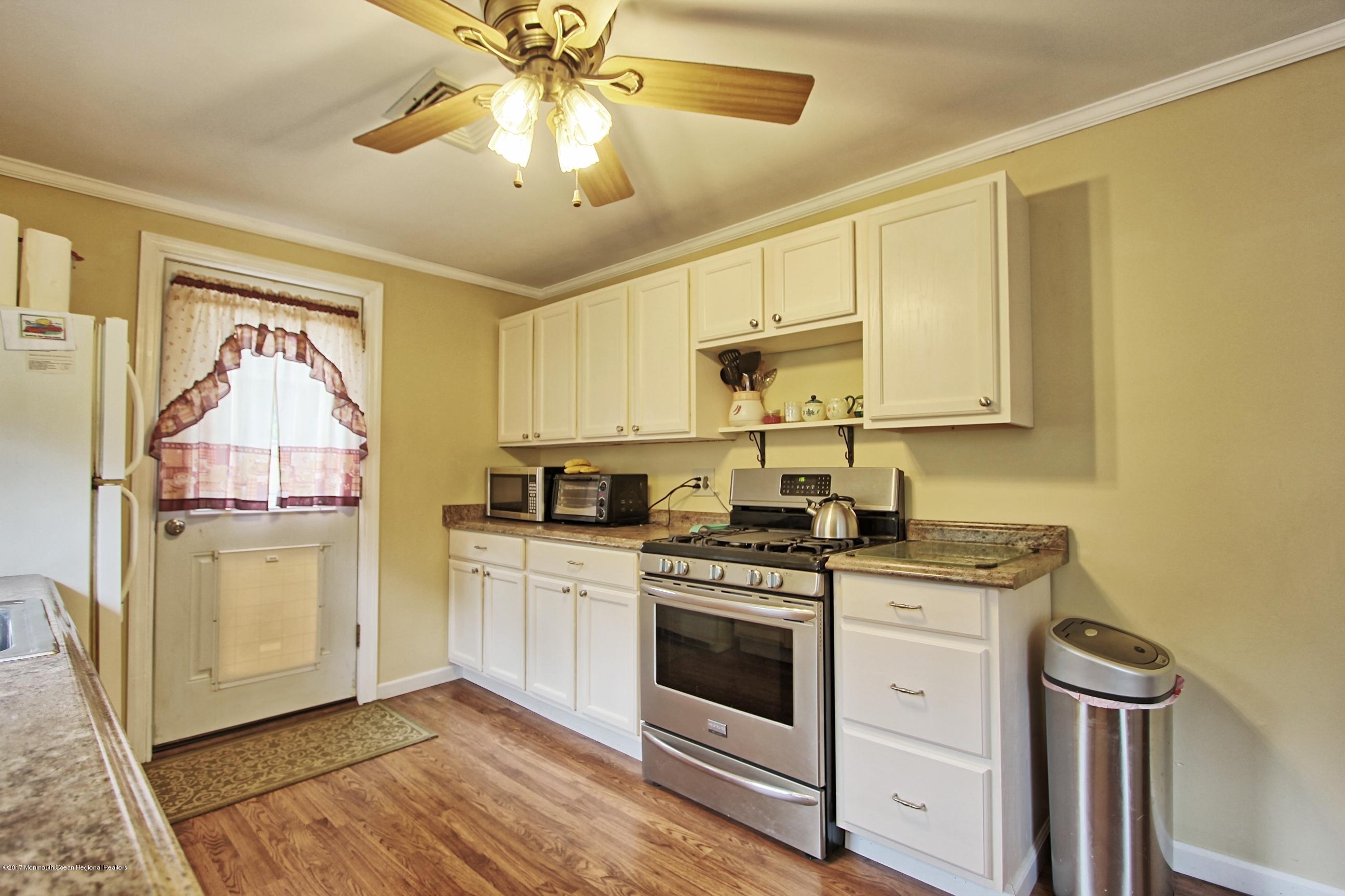 49 Siloam Road Freehold, NJ 07728 - Photo 5 of 38 a kitchen with a stove a sink and a refrigerator