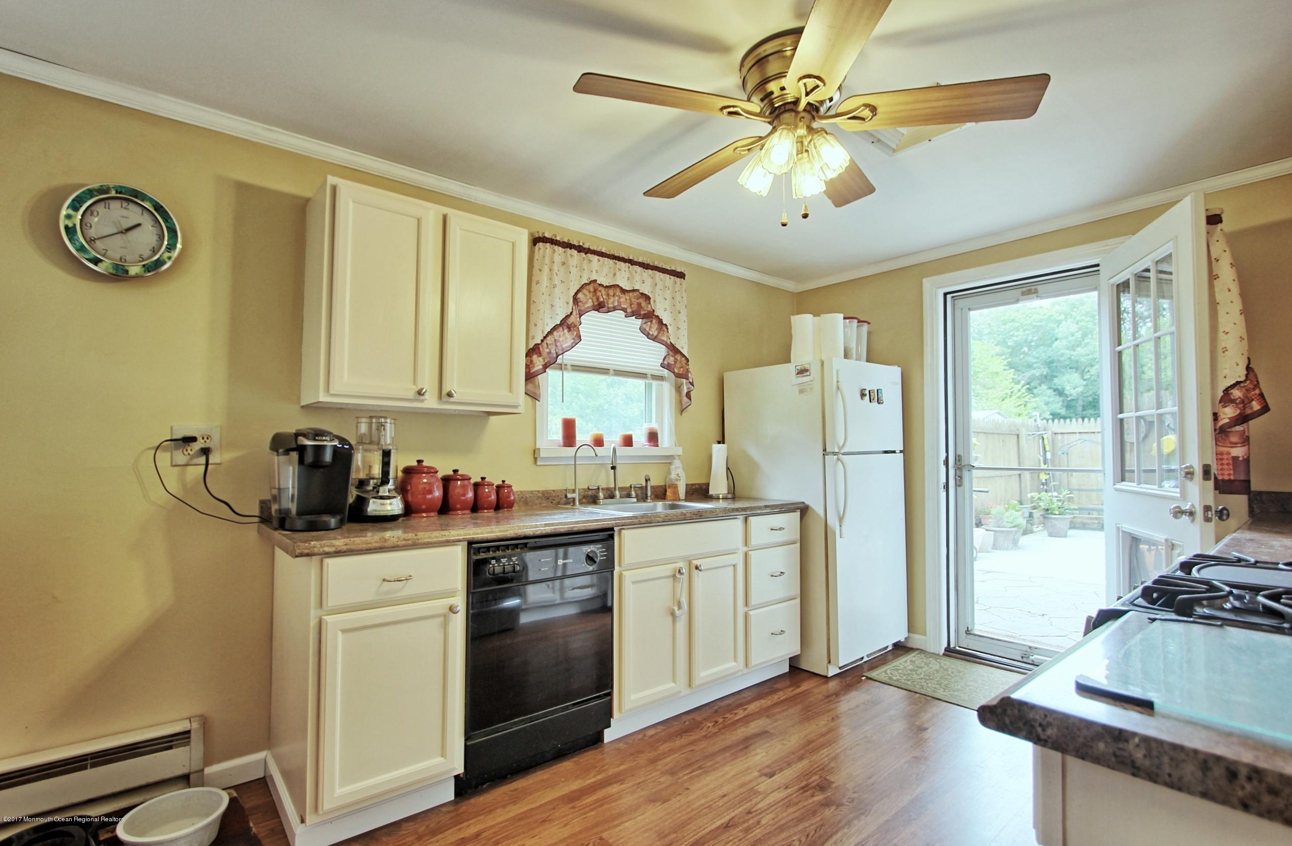 49 Siloam Road Freehold, NJ 07728 - Photo 6 of 38 a kitchen with stainless steel appliances granite countertop a stove refrigerator and cabinets