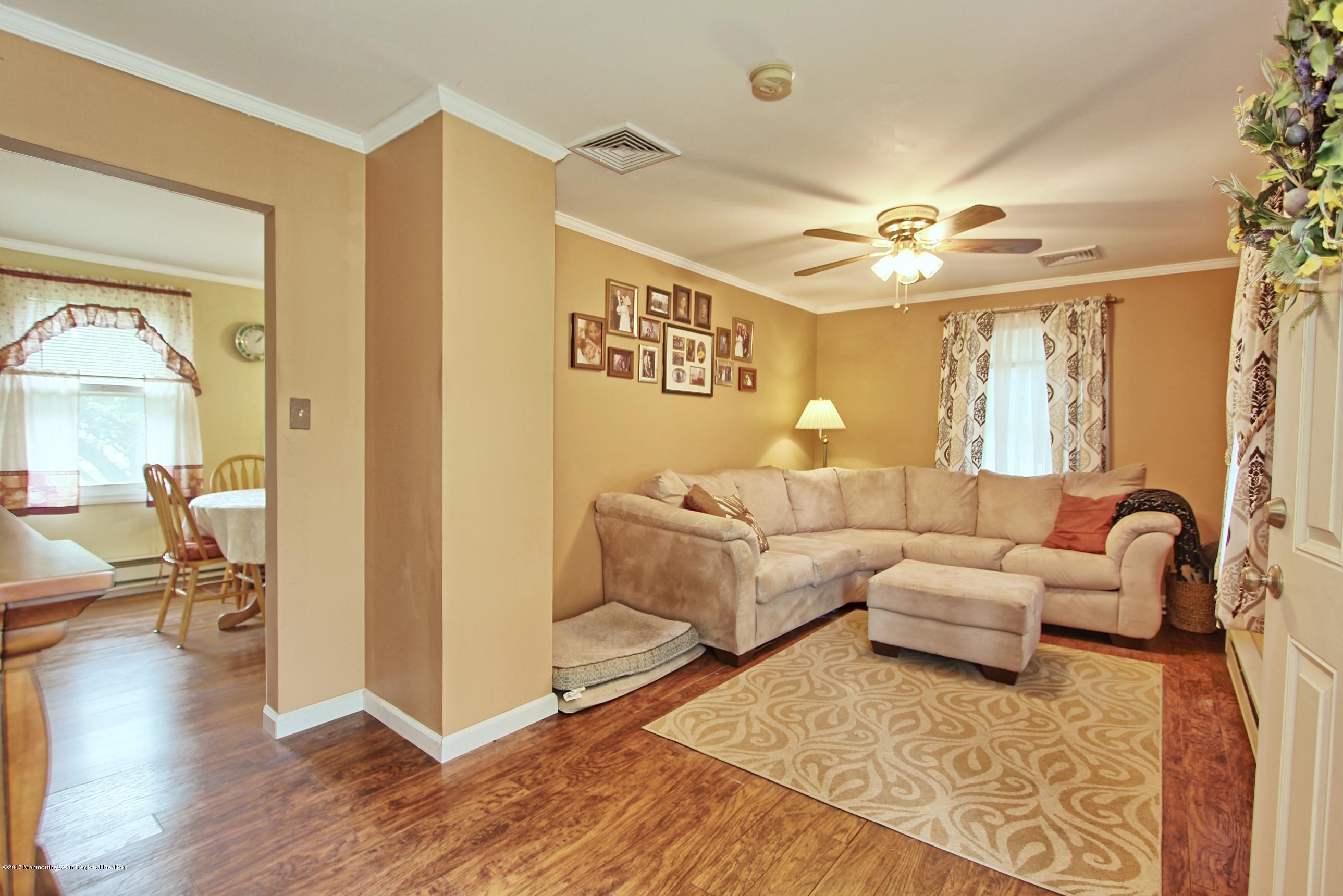 49 Siloam Road Freehold, NJ 07728 - Photo 8 of 38 a living room with furniture and a chandelier